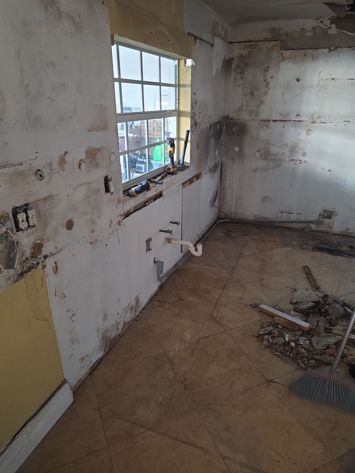 Kitchen stripped to bare walls after fire damage remediation